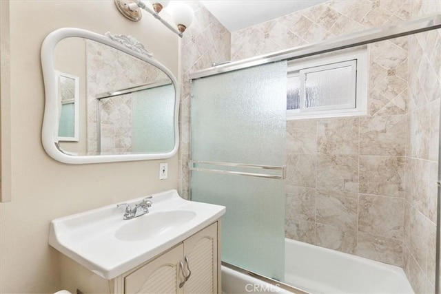 bathroom with enclosed tub / shower combo and vanity