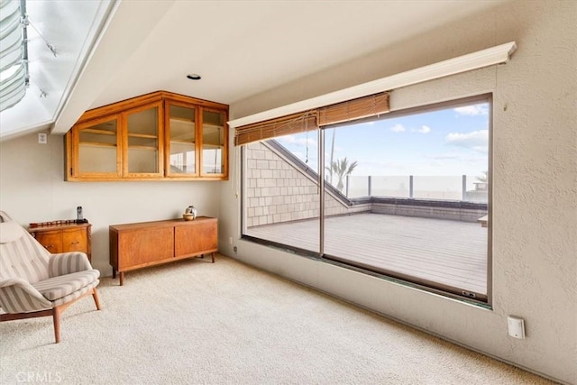 sitting room featuring light colored carpet