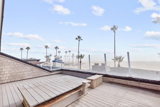 wooden deck featuring a water view