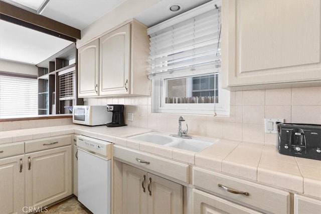 kitchen featuring tile countertops, sink, beam ceiling, and white appliances