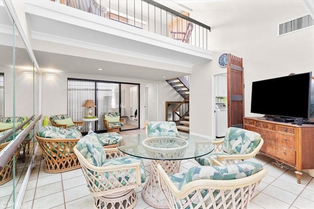 living room featuring a high ceiling and light tile patterned floors