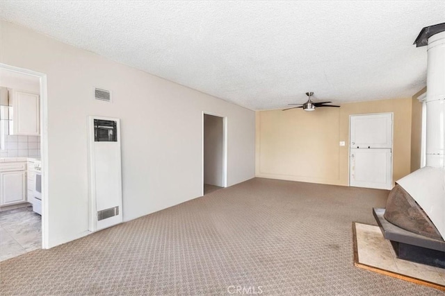 carpeted living room with a textured ceiling and ceiling fan