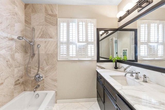 bathroom with tiled shower / bath combo and vanity