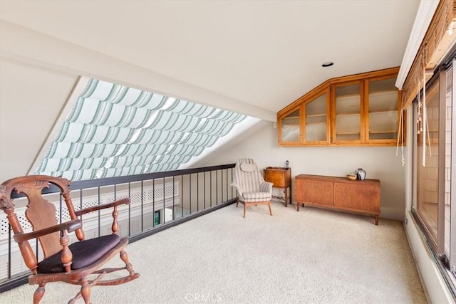 interior space featuring lofted ceiling and light colored carpet