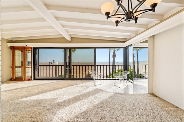 unfurnished sunroom featuring lofted ceiling with beams and an inviting chandelier