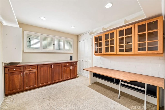 1510 W Oceanfront, Newport Beach, CA 92663 - kitchen with brown cabinetry, light carpet, glass insert cabinets, recessed lighting, and light countertops