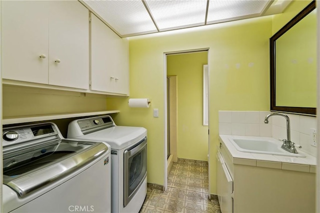 1510 W Oceanfront, Newport Beach, CA 92663 - laundry room with cabinet space, a sink, baseboards, light floors, and washer and dryer