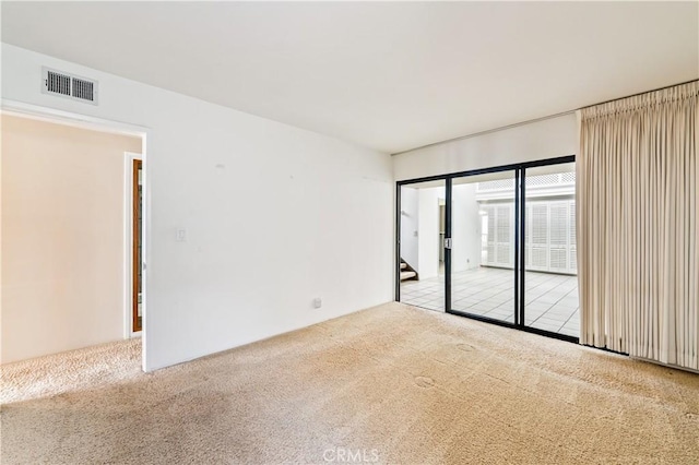 empty room with carpet and visible vents