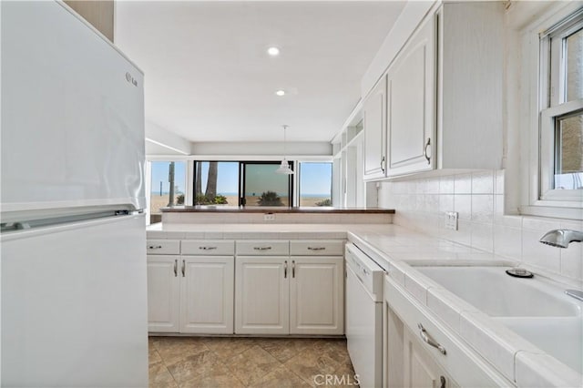 1510 W Oceanfront, Newport Beach, CA 92663 - kitchen with a peninsula, white appliances, light countertops, white cabinetry, and a sink