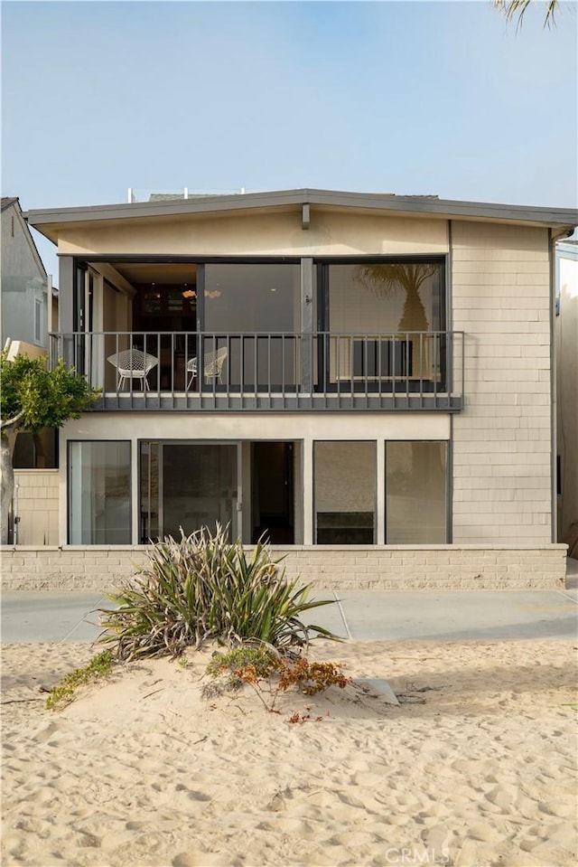 rear view of property featuring a balcony