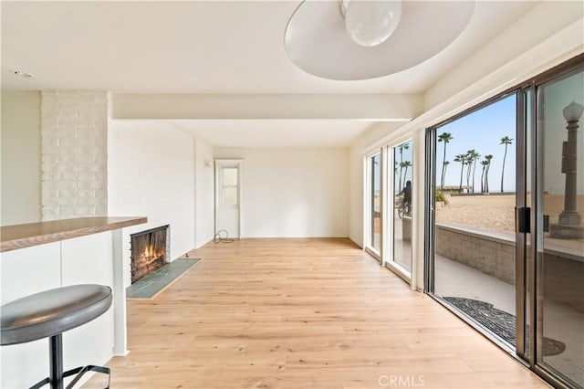 interior space with light wood-type flooring and a fireplace