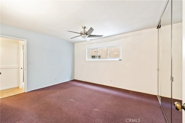 carpeted empty room featuring ceiling fan