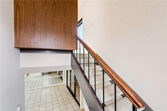 stairs with tile patterned floors