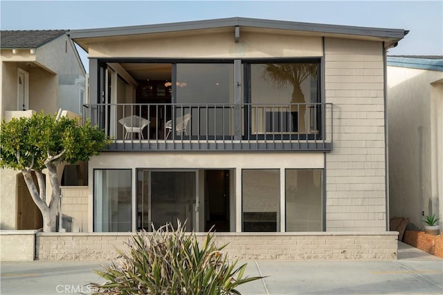 back of property featuring a balcony