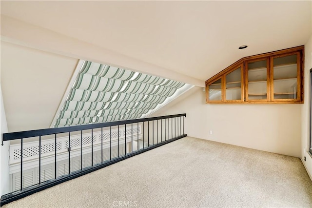 bonus room featuring lofted ceiling and carpet flooring