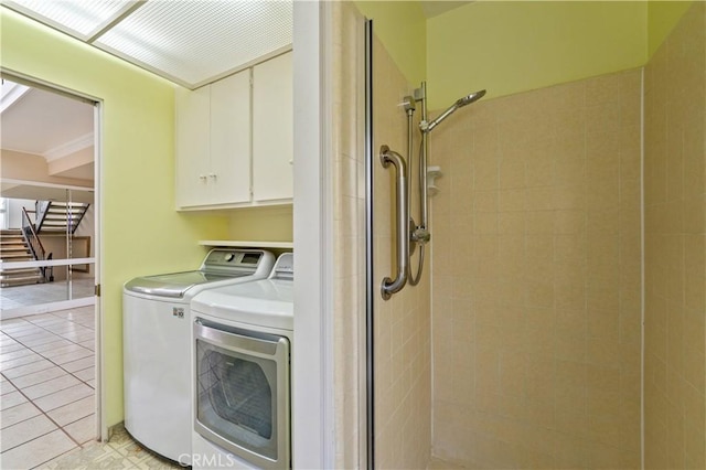 laundry area featuring laundry area, washer and clothes dryer, and light tile patterned flooring