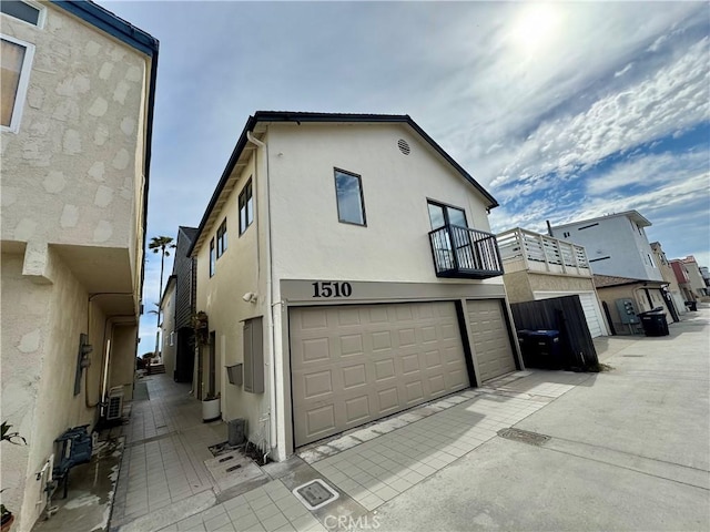 1510 W Oceanfront, Newport Beach, CA 92663 - view of front of home with a balcony, stucco siding, and a garage