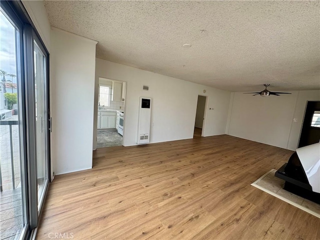 1510 W Oceanfront, Newport Beach, CA 92663 - unfurnished living room featuring light wood-style floors, a textured ceiling, and ceiling fan