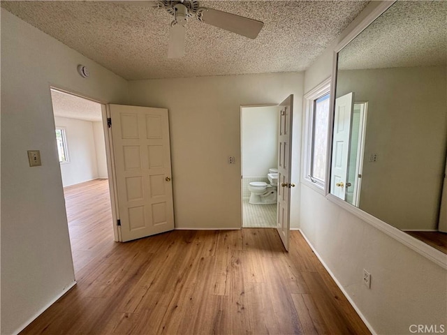 1510 W Oceanfront, Newport Beach, CA 92663 - unfurnished bedroom featuring wood-type flooring, a textured ceiling, ensuite bathroom, and ceiling fan