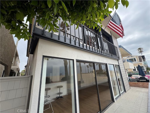 1510 W Oceanfront, Newport Beach, CA 92663 - rear view of property featuring a balcony and stucco siding