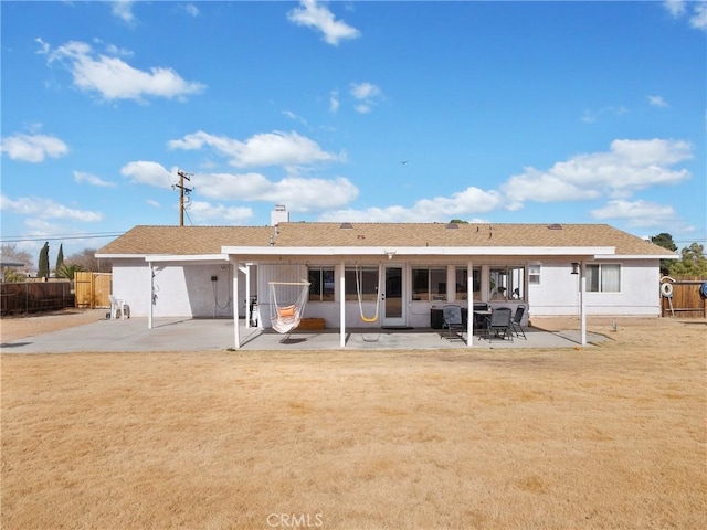 rear view of property with a yard and a patio