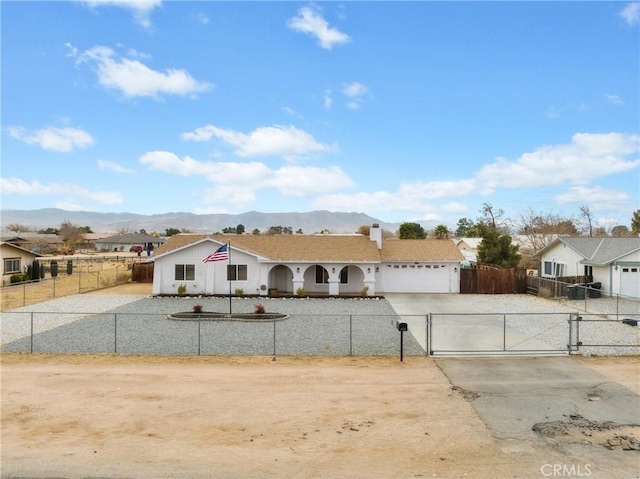 single story home featuring a mountain view and a garage