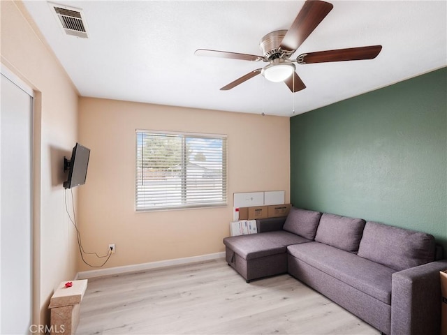 living room featuring ceiling fan and light wood-type flooring