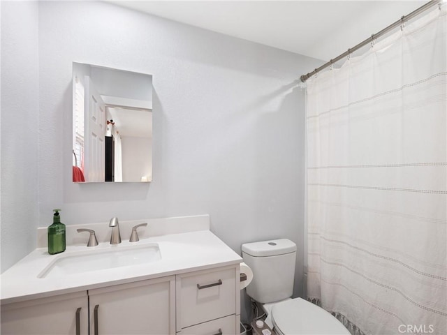 bathroom featuring toilet and vanity