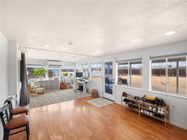 sunroom / solarium with an AC wall unit