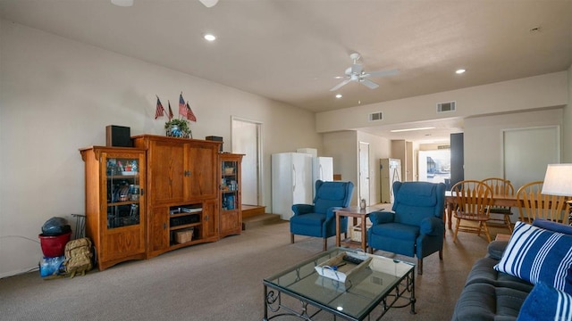 carpeted living room with ceiling fan