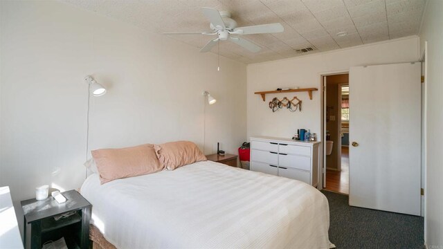 bedroom featuring ceiling fan and dark colored carpet