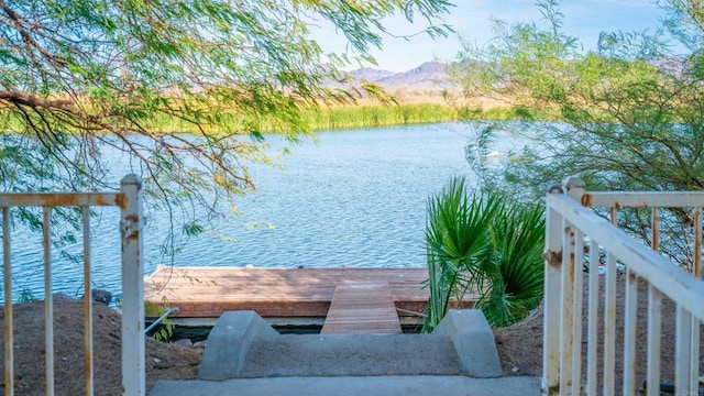 view of dock with a water and mountain view