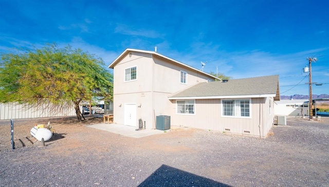 back of property with central AC