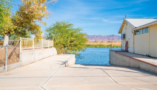 view of patio / terrace with a water and mountain view