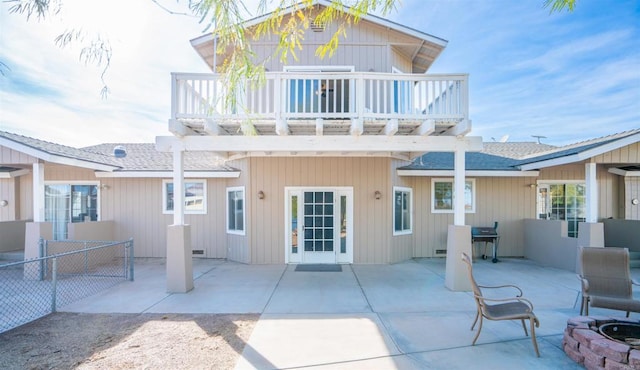 rear view of house featuring a patio area and a balcony