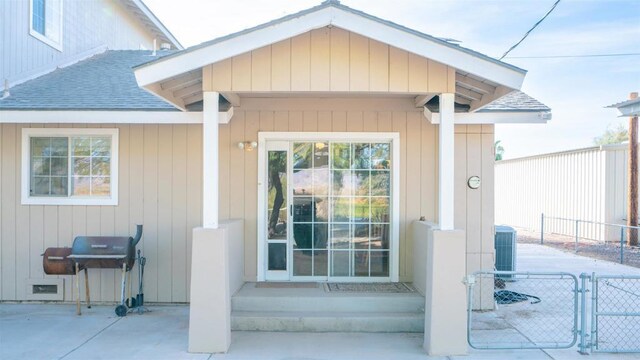 2564 Walters Camp Rd, Winterhaven, CA 92283 - view of exterior entry featuring a shingled roof, a gate, a patio area, and central AC