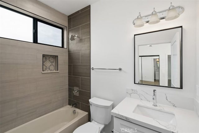 full bathroom with toilet, tiled shower / bath, and vanity