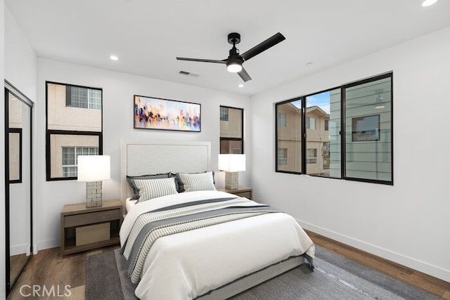 bedroom featuring ceiling fan and dark hardwood / wood-style floors