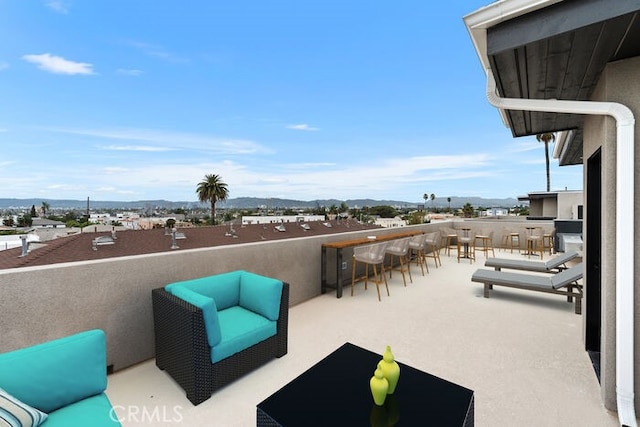 view of patio with an outdoor living space and exterior bar