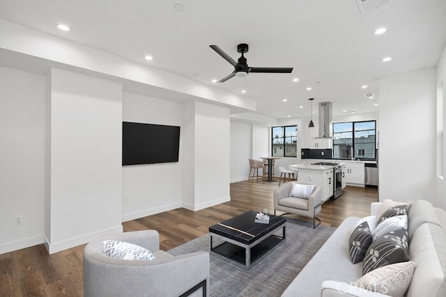 living room featuring ceiling fan and dark hardwood / wood-style floors