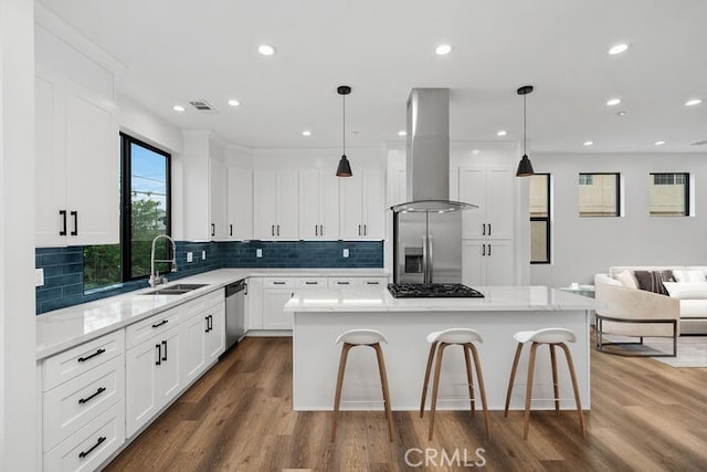 kitchen featuring a kitchen island, sink, island exhaust hood, hanging light fixtures, and appliances with stainless steel finishes