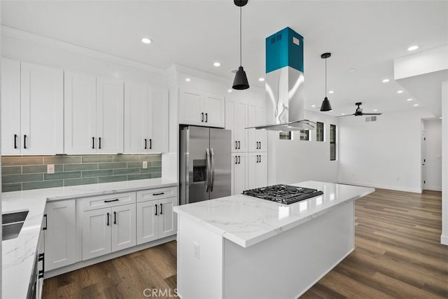 kitchen featuring white cabinetry, ceiling fan, appliances with stainless steel finishes, pendant lighting, and light stone counters