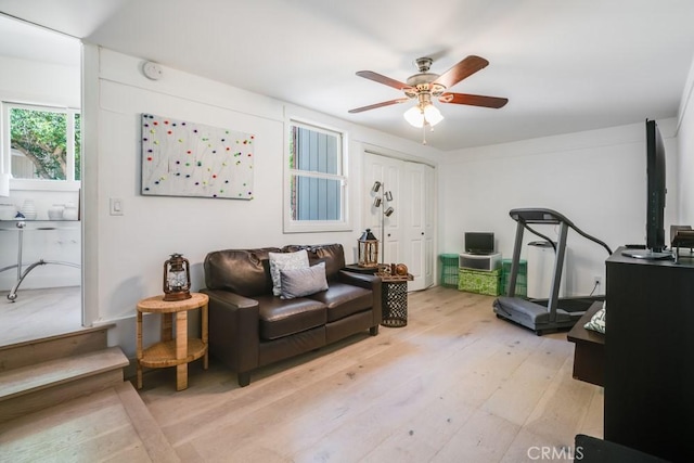 living room with light wood finished floors and ceiling fan