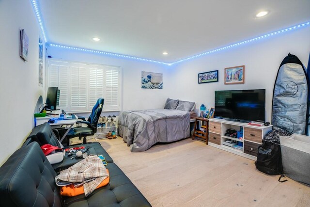 bedroom with recessed lighting and wood finished floors