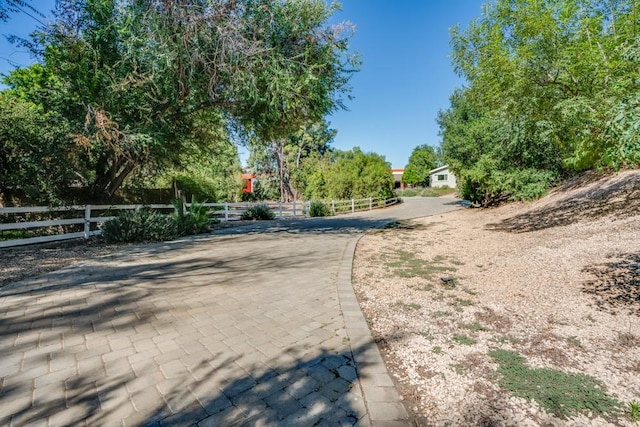 view of street with decorative driveway