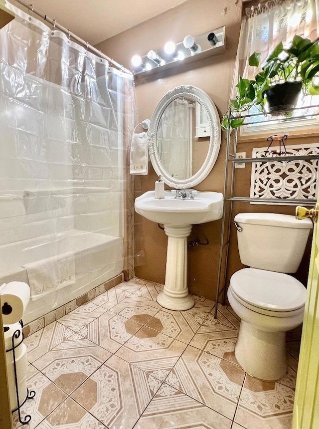 bathroom featuring toilet, tile patterned flooring, and shower / bath combo with shower curtain