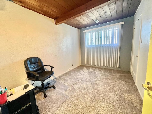 unfurnished office featuring beam ceiling, light carpet, and wood ceiling