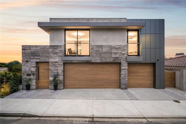 modern home featuring a balcony and a garage