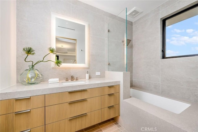 433 Harbor Island Dr, Newport Beach, CA 92660 - bathroom with vanity, tile patterned floors, a bath, tile walls, and a shower