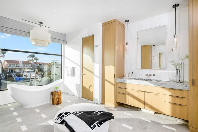 bathroom featuring a washtub and vanity